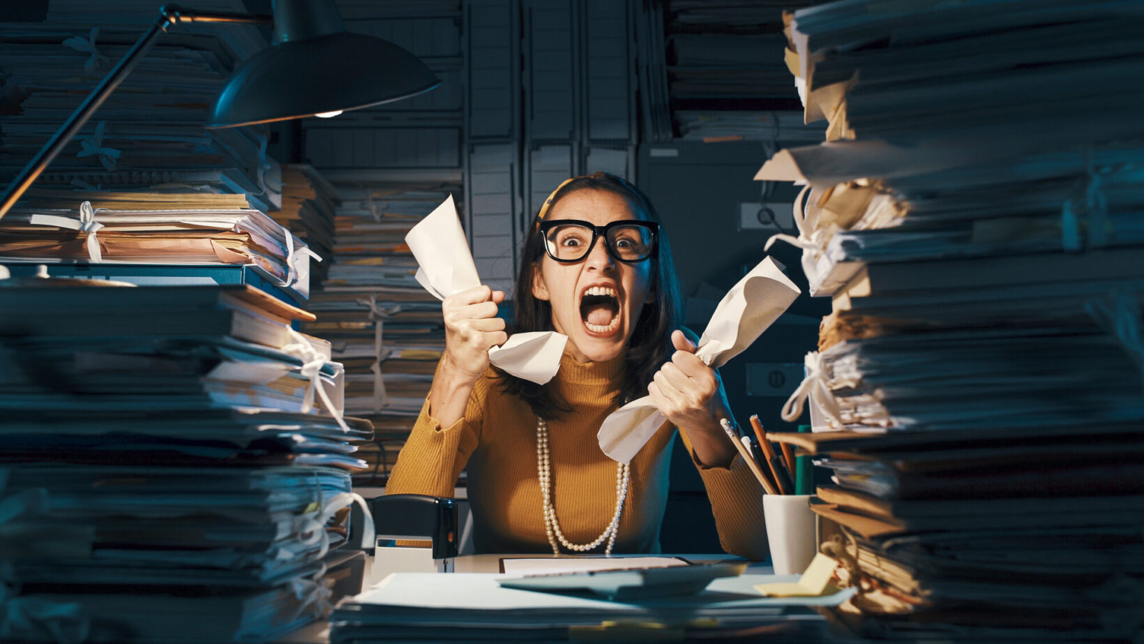 Angry Stressed Office Worker Overloaded With Paperwork Angry Stressed Office Worker Overloaded With Paperwork