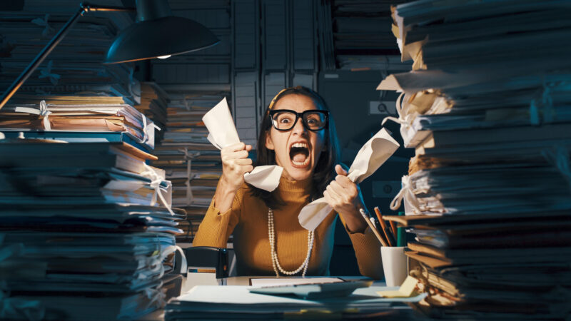 Angry Stressed Office Worker Overloaded With Paperwork
